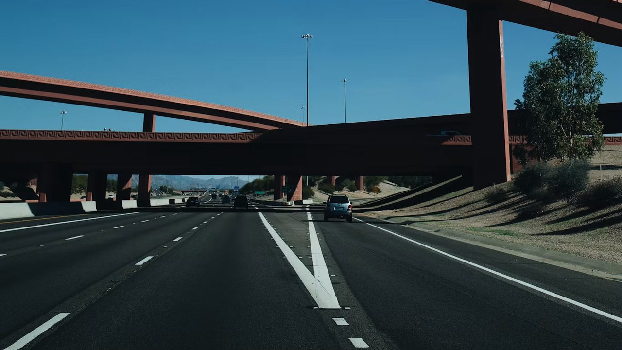 Open highway lanes running out under an Arizona freeway interchange
